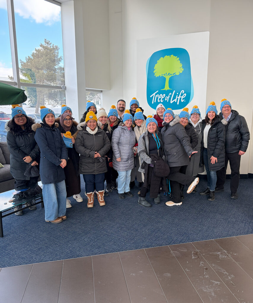 A group of employees cold and wearing toques