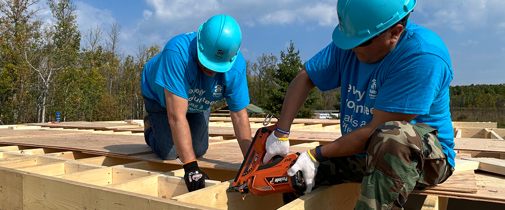 two men framing a roof for habitat for humanity